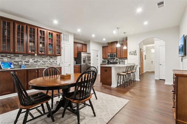 dining room featuring dark hardwood / wood-style flooring and sink