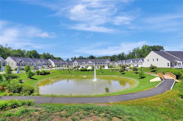 surrounding community featuring a water view and a yard