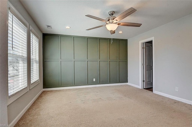 unfurnished room with light carpet and ceiling fan