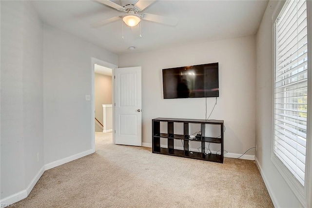 interior space with carpet floors and ceiling fan