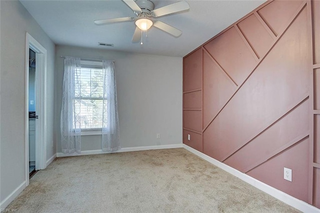 carpeted empty room with ceiling fan