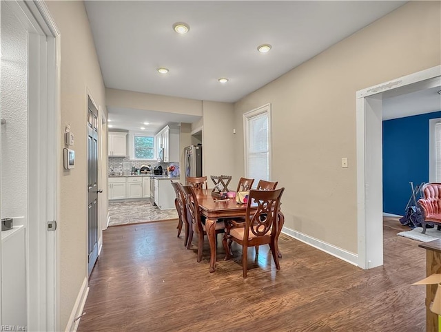 dining space with dark wood-type flooring