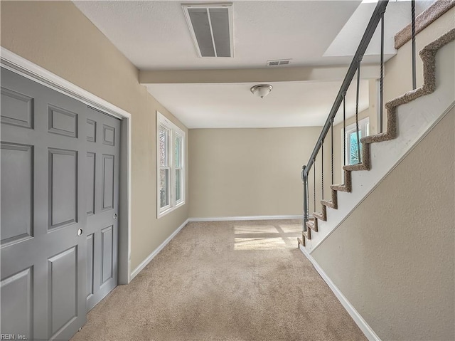 hallway with light carpet