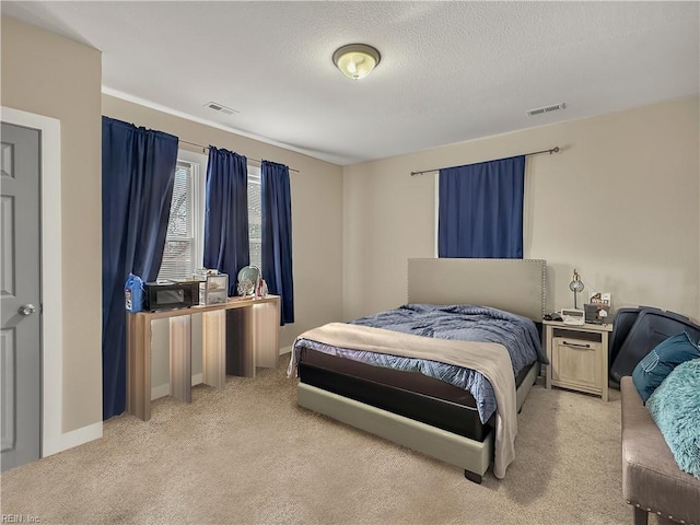 carpeted bedroom with a textured ceiling