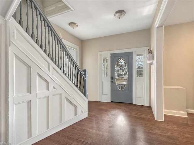 entryway with dark hardwood / wood-style flooring