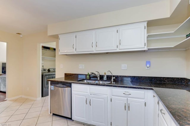 kitchen with light tile patterned flooring, washing machine and clothes dryer, sink, stainless steel dishwasher, and white cabinets