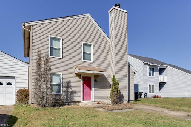 view of front of property featuring a garage and a front lawn