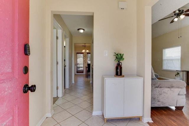 hall featuring light tile patterned floors