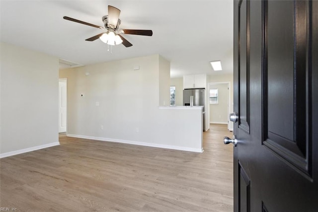 interior space featuring ceiling fan and light wood-type flooring