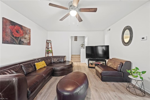 living room featuring ceiling fan and light hardwood / wood-style floors