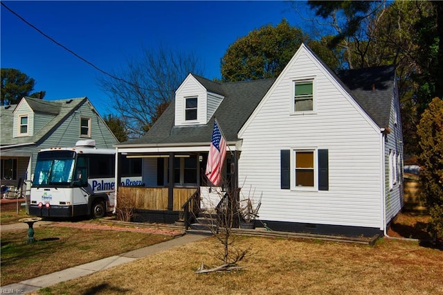 new england style home with a front lawn and a porch