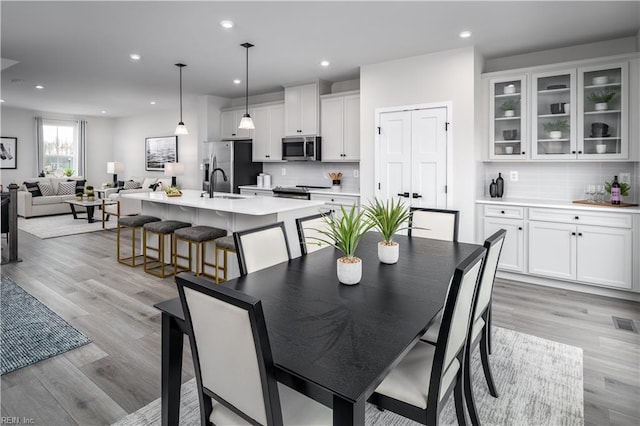 dining room with sink and light hardwood / wood-style floors