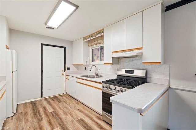 kitchen with sink, white appliances, white cabinets, and light wood-type flooring