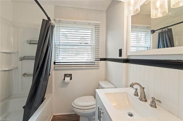 full bathroom featuring vanity, shower / bathtub combination with curtain, and toilet