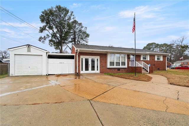 single story home featuring an outbuilding, a garage, and french doors