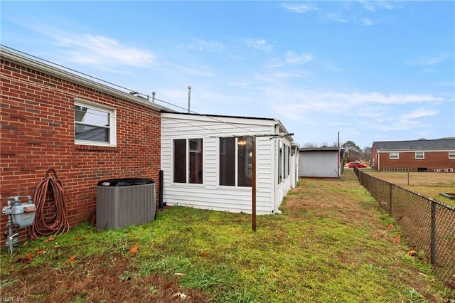 view of property exterior featuring cooling unit and a lawn