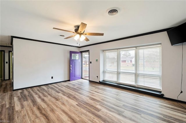 spare room featuring ornamental molding, ceiling fan, and light hardwood / wood-style floors