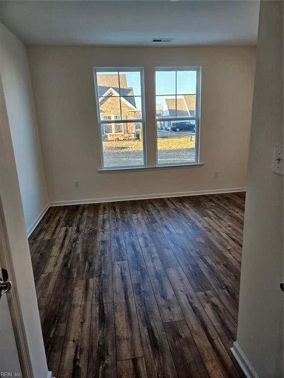 spare room with dark hardwood / wood-style floors