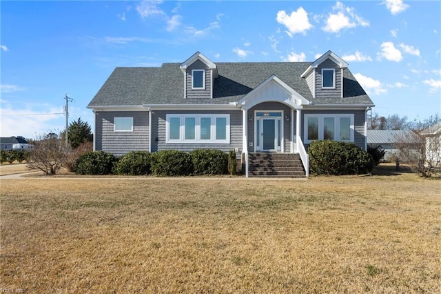 cape cod-style house featuring a front lawn