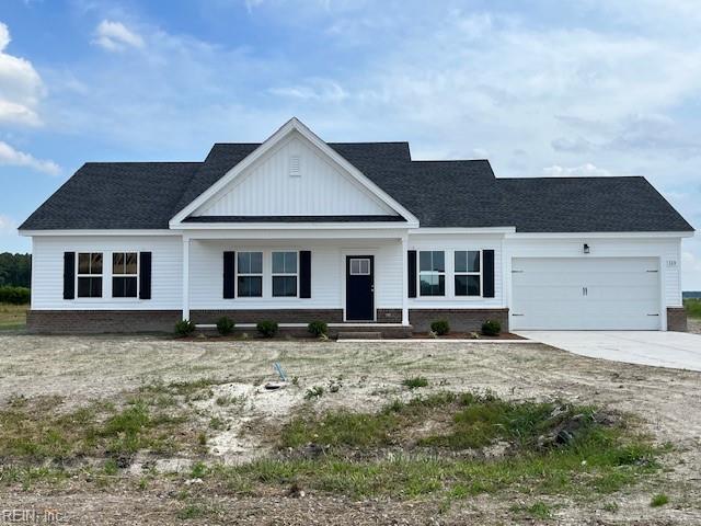 204 Apple Ct, Elizabeth City, NC 27909 - modern farmhouse style home with brick siding, an attached garage, board and batten siding, and driveway