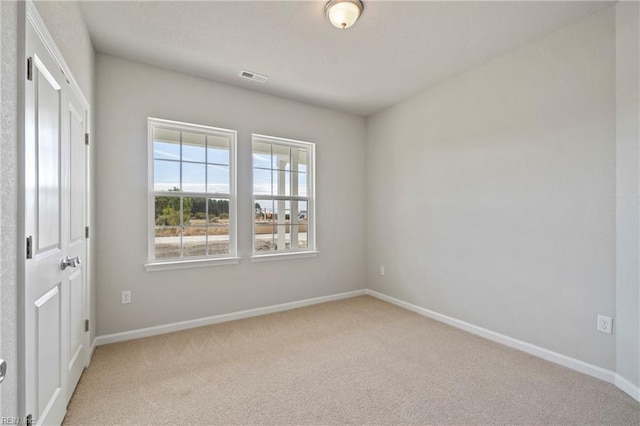 empty room featuring light colored carpet