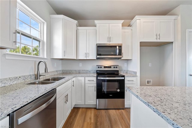 kitchen with white cabinetry, sink, and appliances with stainless steel finishes