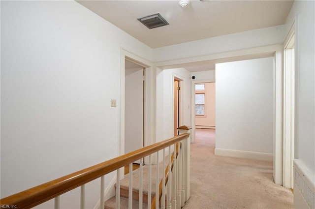 hall with baseboard heating, radiator, and light carpet