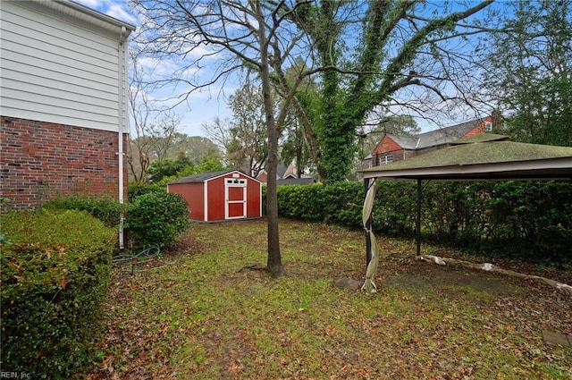 view of yard with a carport and a storage unit