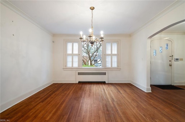 unfurnished dining area featuring crown molding, radiator, hardwood / wood-style flooring, and a notable chandelier