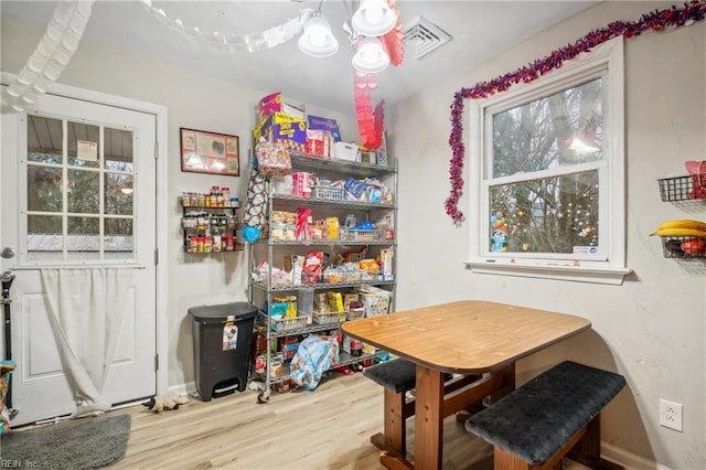 dining area featuring hardwood / wood-style flooring and an inviting chandelier