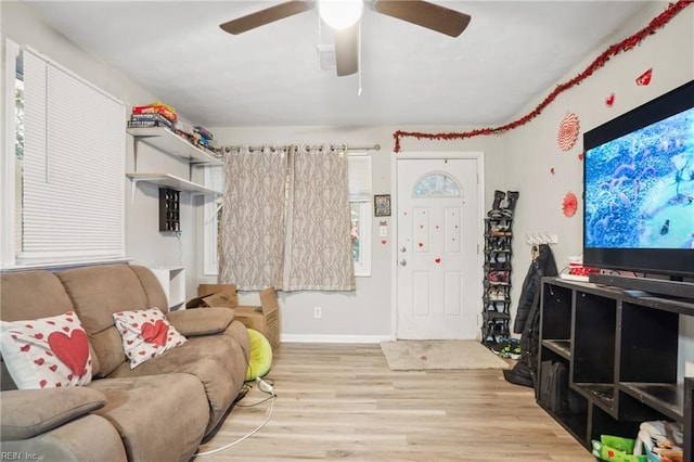 living room with ceiling fan and light hardwood / wood-style floors