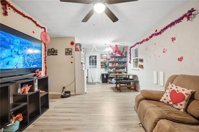 living room with ceiling fan and light hardwood / wood-style flooring