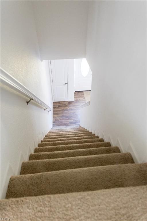 stairway featuring hardwood / wood-style flooring