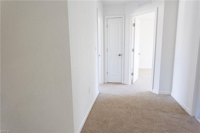 hallway featuring light carpet