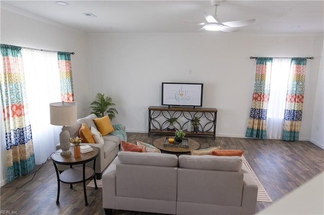 living room featuring ceiling fan, crown molding, dark hardwood / wood-style floors, and a healthy amount of sunlight