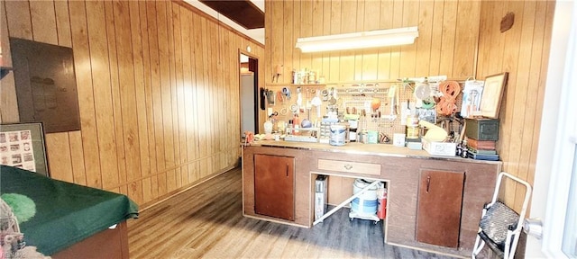 bar featuring hardwood / wood-style floors and wood walls