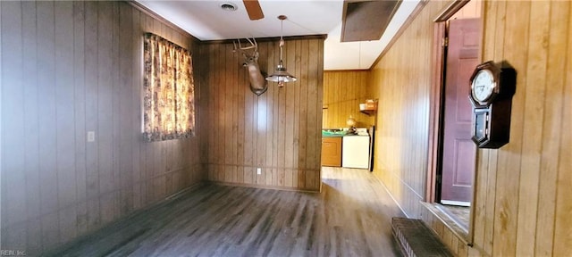 empty room with wood-type flooring and wood walls