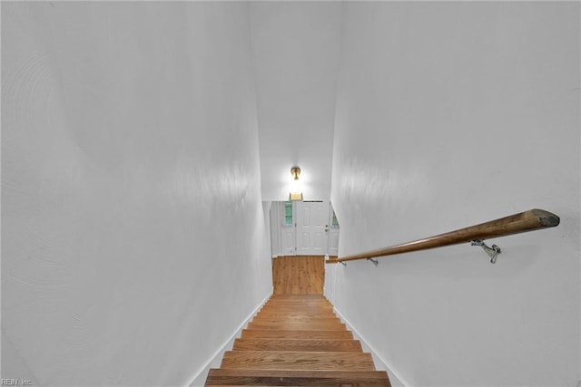 staircase with hardwood / wood-style floors