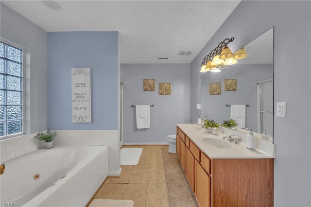 full bathroom featuring vanity, tile patterned floors, shower with separate bathtub, and toilet