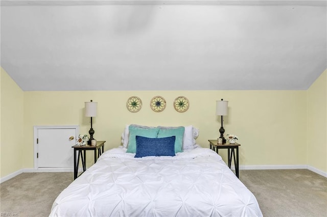 carpeted bedroom with lofted ceiling