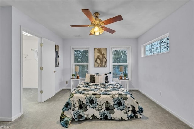 bedroom featuring light carpet and ceiling fan