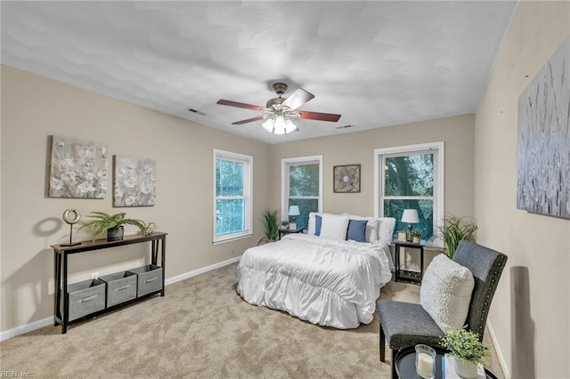 bedroom with ceiling fan and light colored carpet