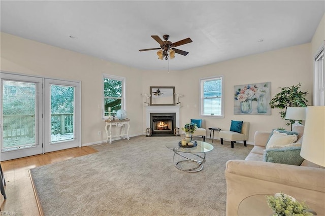 living room with wood-type flooring and ceiling fan