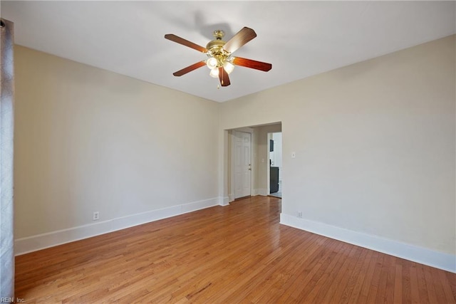 spare room with ceiling fan and light wood-type flooring