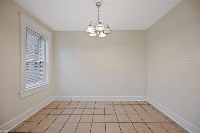 empty room featuring a chandelier