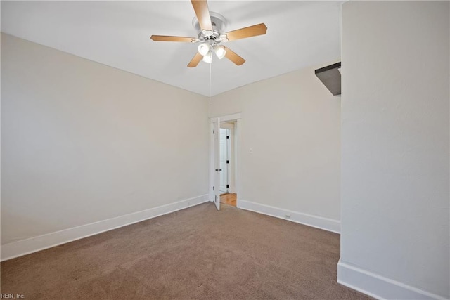 carpeted spare room featuring ceiling fan