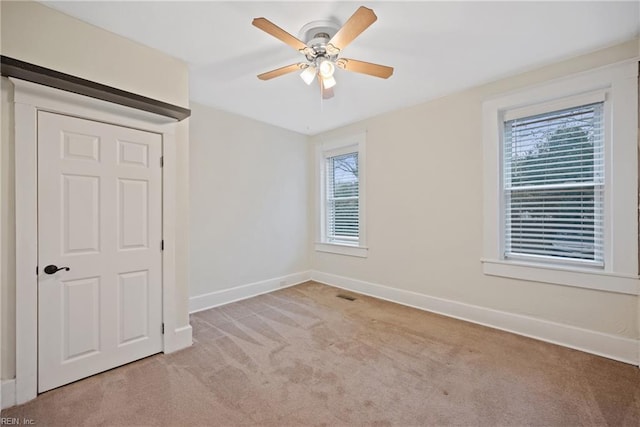 carpeted empty room with ceiling fan