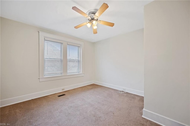 carpeted spare room with ceiling fan