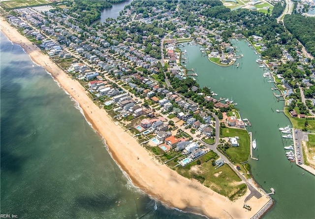 birds eye view of property with a beach view and a water view