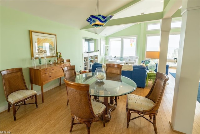 dining area featuring lofted ceiling and light hardwood / wood-style floors